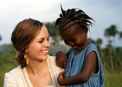 Woman with young African girl
